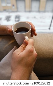 A cup of tea or coffee in the hands of a man. A man drinks hot tea in the morning. Enjoy the comfort of home. White cup close-up in the hands of a man - Shutterstock ID 2109122012