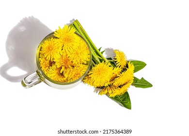 Cup Of Tea With Dandelion Flowers Isolated On A White Background. Breakfast Springtime Concept, Trendy Style, Alternative Medicine. A Hard Light, Dark Shadow, Top View