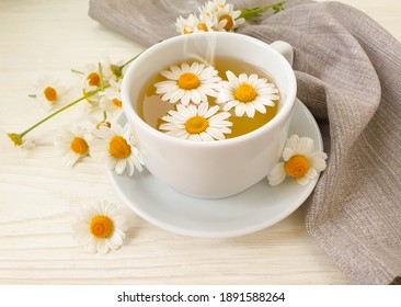 cup tea flower chamomile on wooden background
