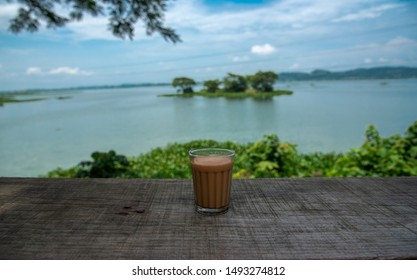 a cup of tea in front of the river