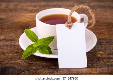 Cup Of Tea With Green Leaves And Blank Tag Ideal For Mockup