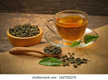 A cup of tea and tea leaf on a background