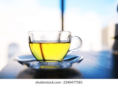 A cup of tea and tea leaf on a background