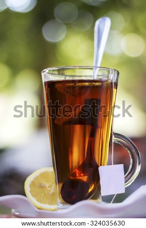 Cup with tea and a lemon, effect bokeah