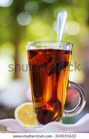 Cup with tea and a lemon, effect bokeah