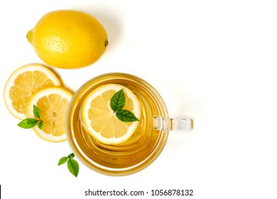 A cup of tea and lemon on a white background. Top view, copy space