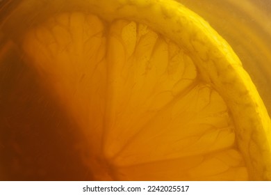 Cup of tea with lemon. A piece of lemon in tea cup. Lemon in tea close-up. Macro shot of lemon and tea. - Shutterstock ID 2242025517