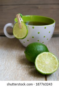 Cup of tea with lime on the wooden table