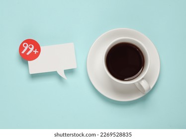 Cup of tea and Notification speech bubble with 99 number on blue background. Social media chat, message, sms, subscribe notice alert and reminder. Top view - Powered by Shutterstock