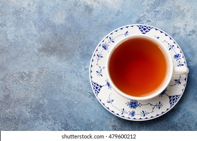 Cup of tea on a blue stone background. Copy space. Top view.