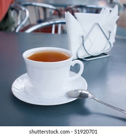 Cup of tea on a table (focus on a cup)