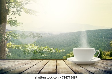 Cup With Tea On Table Over Mountains Landscape With Sunlight. Beauty Nature Background