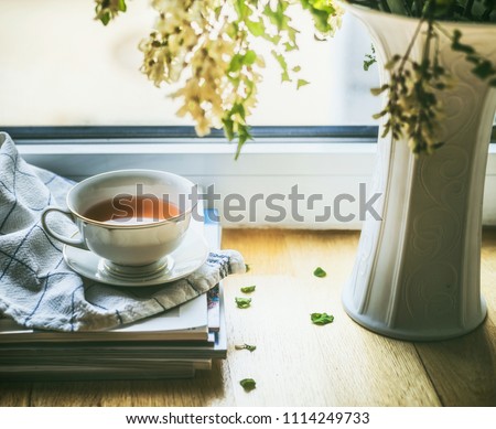 Similar – Still life with cup of tea at the window