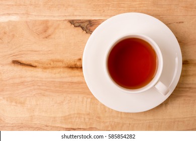 Cup of tea on a wooden background top view.