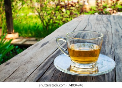 Cup Of Tea On The Wooden Table In The Garden