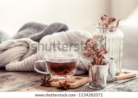 a cup of tea on a wooden table, the concept of autumn and home comfort