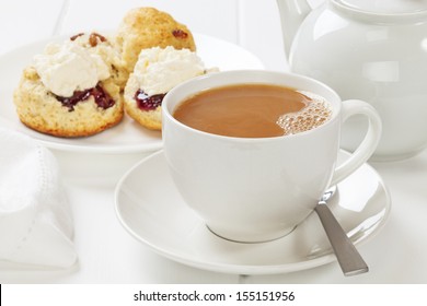 A Cup Of Tea With Scones, Jam And Cream.