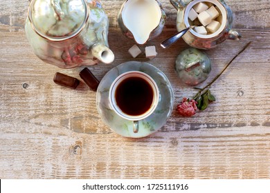 Cup Of Tea Served With Sugar, Milk, Teapot On Light Textured Wooden Table. Concept Of Relax, Holidays, Weekends.