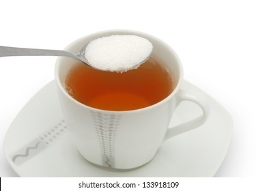 Cup Of Tea With Sugar Isolated Against White