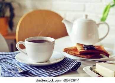 Cup of tea and teapot in kitchen interior closeup - Shutterstock ID 606783944