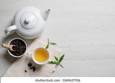 Cup With Tea And Teapot On White Stone Table.Top View With Copy Space.