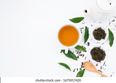 cup with tea and teapot on white  background. green leaves. over light - Powered by Shutterstock