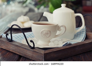 Cup Of Tea And Teapot On Wooden Tray Closeup