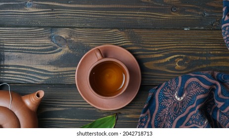 a cup of tea and a teapot on wooden background with copy space. Traditional drink from Indonesian. Flat lay. Food concept. - Powered by Shutterstock