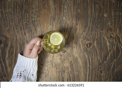 Cup of tea with thyme herb and lemon slices