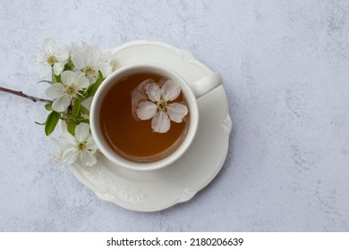 Cup of tea with white flowers on marble table. Minimalist still life in white color. Relaxation, healthy lifestyle, self care concept. Flat lay, top view - Shutterstock ID 2180206639