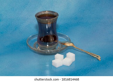 A Cup Of Tee With Suger And Spoon