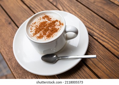 Cup of turkish traditional winter beverage Salep (Sahlep or sahlab) served with cinnamon on top in Istanbul cafe