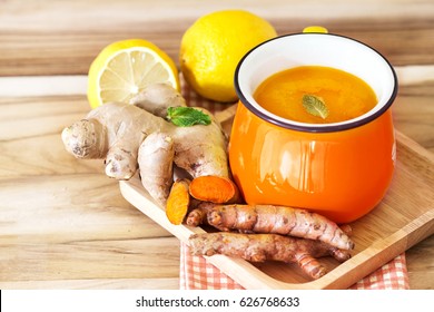 a cup of Turmeric Tea with lemon and ginger , Benefits for reduce Inflammation , Liver Detox and Cleanser healthy herb drink concept