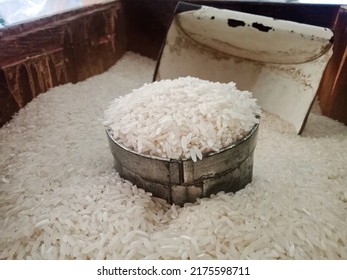 A Cup Of Uncooked Rice Is Being Measured