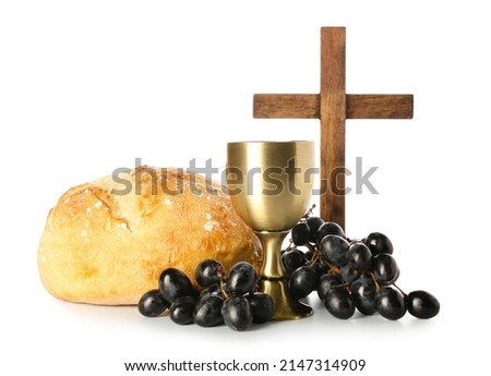 Cup of wine with bread and cross on white background