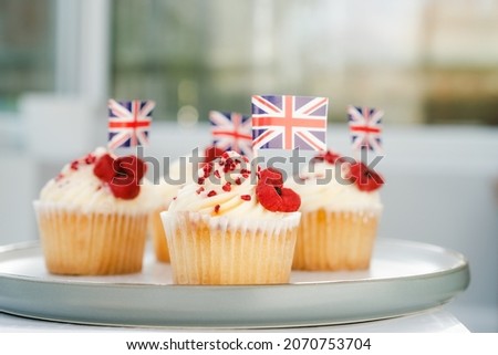 Cupcake with British Union jack flag and poppy flower. Remembrance Day. Selective focus, copy space.