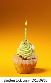 Cupcake With Candle Isolated On Orange Background