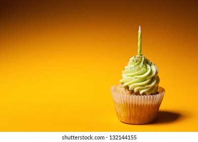 Cupcake With Candle Isolated On Orange Background