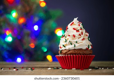 Cupcake. Cupcakes and Christmas Tree. Merry Christmas. Red cup liners. Tasty baking cupcakes, cake or muffin with white cream icing, frosting and colored sprinkles. Homemade bakery, confectionery shop - Powered by Shutterstock