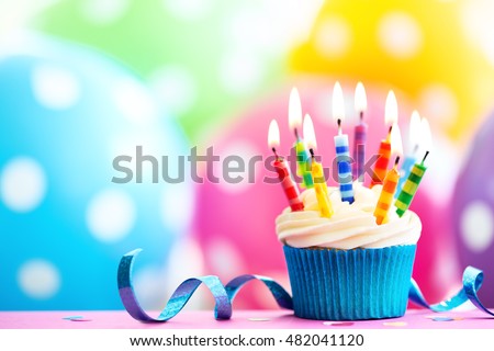 Cupcake decorated with colorful birthday candles