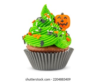 Cupcake On Halloween. Carved Pumpkin. Jack O Lantern. Dessert On Halloween Party. Muffin Decorated With Colored Sprinkles, Candy, Green Frosting And Icing. Chocolate Cupcake. White Isolated Background