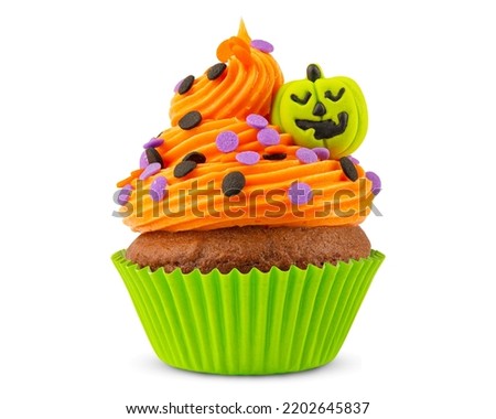 Cupcake on Halloween. Pumpkin Jack o lantern. Dessert on Halloween party. Muffin decorated with colored sprinkles, frosting and Icing shaped pumpkin Jack-o-lantern. Cupcakes. White isolated background