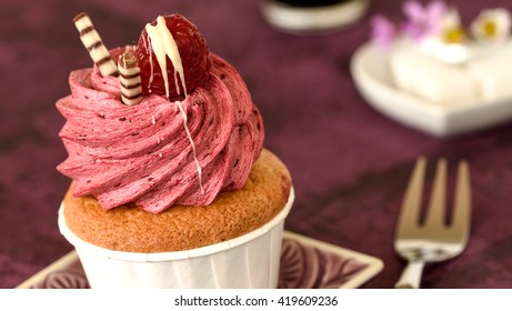 Cupcake with raspberry-close up