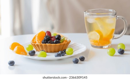 cupcakes with fruits and cold healthy drink on white  table - Shutterstock ID 2366309145