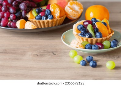 cupcakes with fruits on wooden table on kitchen - Shutterstock ID 2355572123