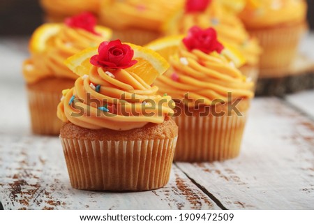 Cupcakes with orange icing on top