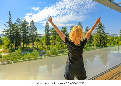 Cupertino, CA, United States - August 12, 2018: Tourist Woman Enjoy The View Of Apple Park With Futuristic Campus From Roof Terrace Of Apple Park Visitor Center In Silicon Valley, California.