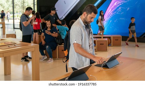 Cupertino, CA, USA - August 2019: Man Examining An IPad In Apple Store In Cupertino, Apple Headquarters Infinite Loop