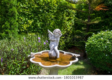 Cupid Statue decorated in the botany garden 