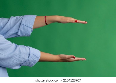 Cupped hand gesture on green background.  